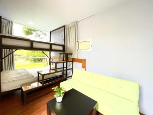 a living room with bunk beds and a table at 虎山哩賀 Hello-Hu Shan in Rende