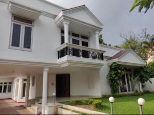 a white house with a porch and columns at Regalia Home Sapphire Stay in Jammu