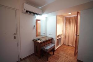 a bathroom with a wooden desk and a mirror at 1775 Adriatico Suites in Manila
