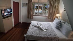 a white ribbon on a bed in a bedroom at 1775 Adriatico Suites in Manila