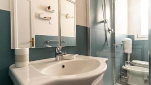 a bathroom with a sink and a toilet and a mirror at Italianway - Riva di Reno 47 B in Bologna +15 photos