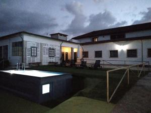 a house with a tub in the yard at night at Guesthouse Casa das Abegoarias in Celorico de Basto