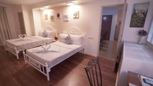 a room with two beds and a hallway with a staircase at 1775 Adriatico Suites in Manila