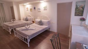 a room with two beds in a room at 1775 Adriatico Suites in Manila
