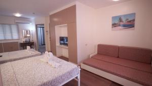 a small room with two beds and a couch at 1775 Adriatico Suites in Manila
