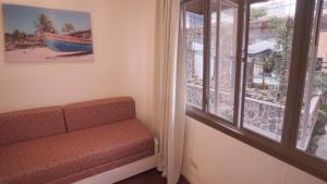 a living room with a couch and a window at 1775 Adriatico Suites in Manila
