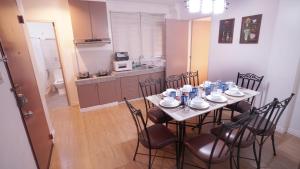 a dining room table with chairs and a kitchen at 1775 Adriatico Suites in Manila