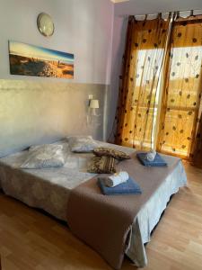a bedroom with a bed with two towels on it at Appartamento Alessandra in Finale Ligure