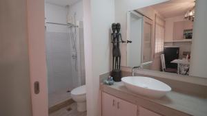 a bathroom with a sink and a toilet and a shower at 1775 Adriatico Suites in Manila