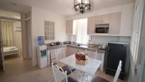 a kitchen with a table and a black refrigerator at 1775 Adriatico Suites in Manila