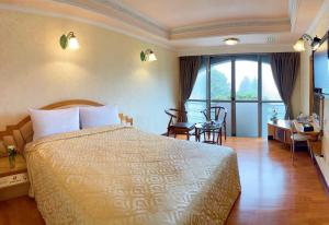 Postel nebo postele na pokoji v ubytování Kao Feng Hotel