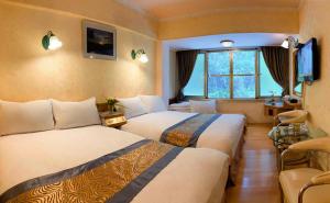 Postel nebo postele na pokoji v ubytování Kao Feng Hotel