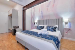 a bedroom with a large bed with two stuffed animals on it at Hotel Cosmos in Florence +74 photos