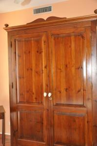 a wooden cabinet in a room with a wall at Villa Giusy 2 appartamenti indipendenti a locazione turistica breve -G&P HOLIDAY HOME in Valderice