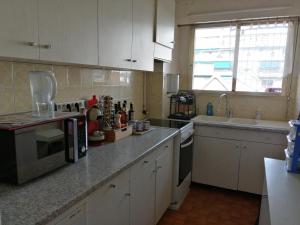 a kitchen with white cabinets and a counter top at Grand 2 pièces Centre ville Antibes in Antibes