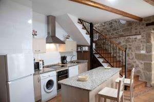 a kitchen with a sink and a stove top oven at El Capricho 2 in Villamiel