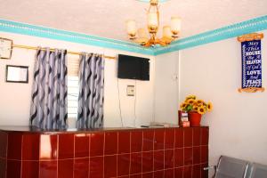 a meeting room with a mirror and a desk with a television at Bilkon Hotel Jinja in Jinja