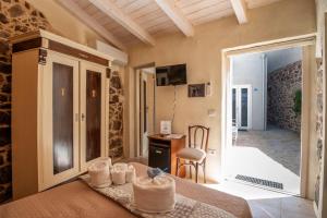 a bedroom with a bed with towels on it at Domo Sa Barra in SantʼAntìoco