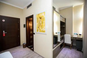 a hotel room with a bathroom with a desk and a mirror at Hotel Partner in Vlorë