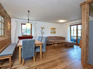 a living room with a table and chairs and a couch at Ferienhof Dirnberg in Amerang