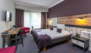 Postel nebo postele na pokoji v ubytování UPA Medical SPA