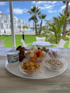 a plate with different types of food on a table at Island Home Fuerteventura in Corralejo