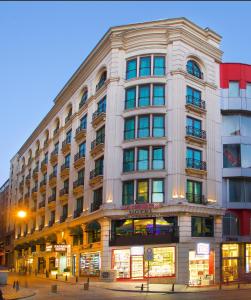 a large white building on the corner of a street at Zagreb Hotel in Istanbul