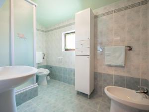 a bathroom with a sink and a toilet at Holiday Home Medica - PZN318 by Interhome in Tinjan