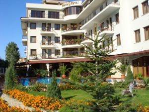 a hotel with a garden in front of it at Villa Maria Revas in Sunny Beach