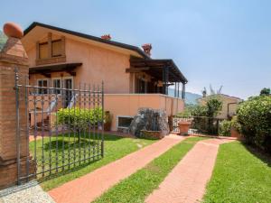 a house with a fence in front of a yard at Apartment Serenella by Interhome in Pietrasanta
