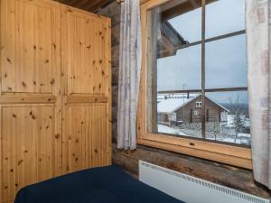 a room with a window with a view of a house at Holiday Home Ahmanportti 2 by Interhome in Ylläs