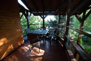 un porche cubierto con mesa y sillas en B&B Casa Mica Guesthouse, en Bucarest