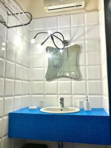 a bathroom with a sink and a purse on the wall at Monolocale in Perugia