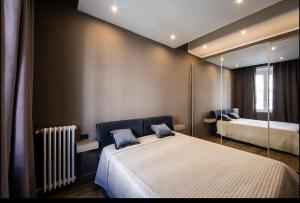 a bedroom with a bed and a mirror at NEW AMAZING BILO apartment in the heart of Milan from Moscova Suites apartments group in Milan