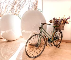 a bike parked next to two white vases at Mareta Beach - Boutique Bed & Breakfast in Sagres