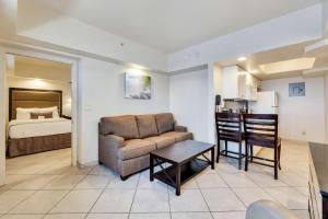 a living room with a couch and a kitchen with a bed at Best Western Plus Beach Resort in Fort Myers Beach