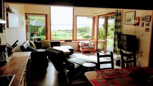 a living room with a couch and a table at Villa Beata in Nowe Warpno
