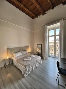 a bedroom with a large bed and a large window at Bellini View in Naples