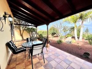 a table and chairs on a patio with a view at CASA Mar y Teide in Sauzal