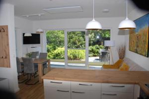 a kitchen and living room with a table and a dining room at Ferienhaus Sonnenschein in Insel Poel