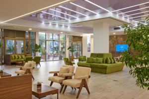 a lobby with couches and chairs and a tv at Azul Beach Resort Montenegro by Karisma - All Inclusive in Ulcinj