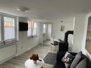 a living room with a couch and a table at Ferienapartment Stemmert in Gelting