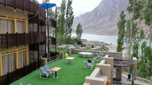 a building with a green yard with chairs on it at Famree Resort Hunza in Hunza Valley