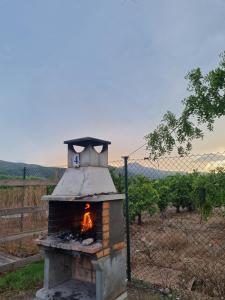 a brick oven with a fire inside of it at Camping la Naranja in Gandía