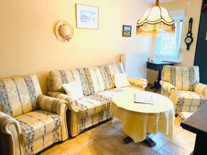 a living room with two couches and a table at Ferienhaus Matthies in Kolpinsee