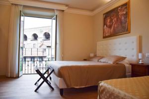 a bedroom with a bed and a large window at Hotel Salis in Rome