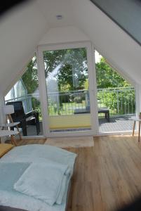 a room with a bed and a large window at Ferienhaus Sonnenschein in Insel Poel