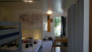 a bedroom with a bed and a dining room with a table at Residence Alassa in Montévrain