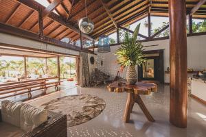 a living room with a table and a couch at Kaza Mazamore - Entire luxurious Vila in Itaunas. in Conceição da Barra