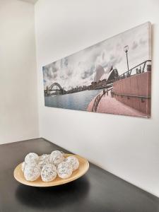 a plate of donuts on a table under a painting at Gästehaus "Duvenstedter Brook" 